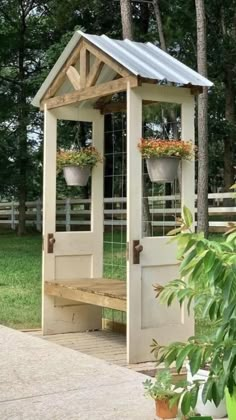 a small wooden structure with potted plants on it