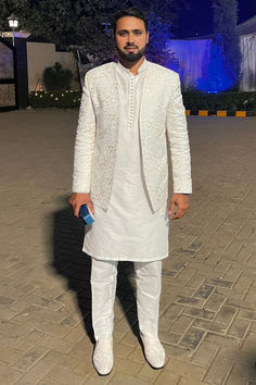 Our esteemed happy client, Pakistani star cricketer Mr. Faheem Ashraf looking absolutely stunning in open front white prince coat with kurta pajama designed by Uomo Atire.

- It's custom-made, so it's guaranteed to fit you perfectly. Traditional Suits With Dupatta For Reception, Naqshi Lawn Suit For Wedding With Traditional Drape, Wedding Unstitched Suit With Naqshi For Eid, Wedding Lawn Suit With Naqshi In Traditional Drape, Wedding Naqshi Lawn Suit With Traditional Drape, Wedding Naqshi Unstitched Suit For Eid, Wedding Eid Unstitched Suit With Naqshi, Wedding Eid Naqshi Unstitched Suit, Wedding Nehru Jacket In Jamawar With Dabka Detail