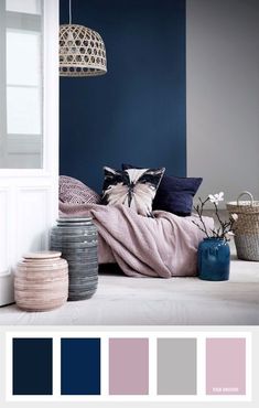 a bedroom with blue walls and white furniture, including a pink blanket on the bed