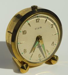 This vintage Elgin alarm clock is a beautiful addition to any collection. With its classic analog display and mid-20th century style, it's sure to catch the eye of any clock enthusiast. Measuring 6cm in height and length, this clock is the perfect size for any bedside table. The gold color adds a touch of elegance to any room. It's perfect for those who appreciate vintage and retro styles, but also want a reliable timepiece. Whether you're a collector or just looking for a unique clock, this Elgin alarm clock is a great choice. Repurposed Alarm Clocks, Vintage Alarm Clocks Dogitsl, Retro Styles, Unique Clocks, The Eye, Alarm Clock, Bedside Table, Time Piece, 20th Century