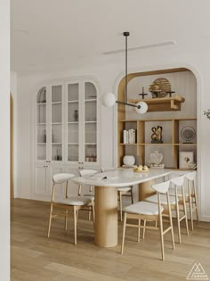 the dining room table is surrounded by white chairs and built - in bookcases