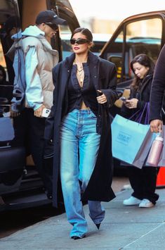 a woman walking down the street carrying shopping bags