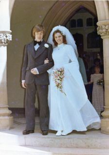 a young man and woman in formal wear posing for a photo on their wedding day