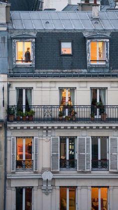 an apartment building with many windows and balconies