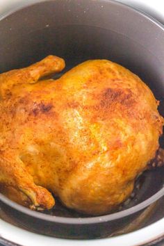 a cooked chicken in a pot on the stove