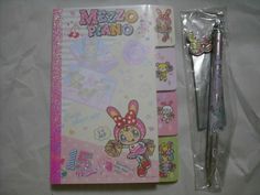 a set of three stationery items including a pen, notebook and sticker sheets