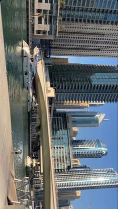 an aerial view of skyscrapers and buildings in the city, taken from below on a sunny day