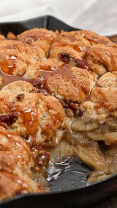 a pan filled with apple pies covered in caramel drizzled sauce