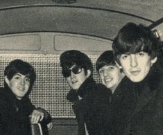 the beatles are posing for a photo in their car