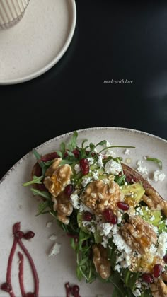 a white plate topped with food on top of a black table next to other plates