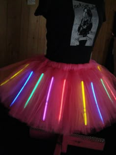 a light up tutu skirt with neon lights on it and a t - shirt in the background