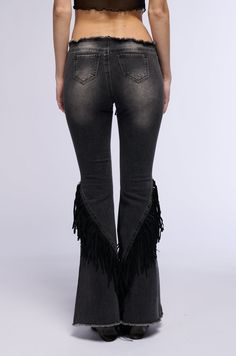 Calling all cowgirls. The AKIRA Label Rodeo Fringe Low Rise Flare Jeans are super stretchy washed denim bottoms that feature a waistband-less low rise design, frayed hems, faux hematite metallic hardware, back pouch pockets, and Western-inspired swirly embroidered patterning on the thighs, adorned with circular studded embellishments. Complete with a flared leg silhouette, detailed with tiered faux suede fringe, and a self-tie lace up front closure. Top off your look with a faux leather corset top, Western booties, and an embroidered cowgirl hat.  - 68% Cotton 30.5% Polyester 1.5% Spandex - Super Stretchy - Imported (all measurements are approximate from size small) - 9.25” Rise  - 33.5” Inseam - Model is 5’9” Product ID: 391064 (all measurements are approximate from size 1X) - 11” Rise - Denim Bottoms, All White Party, Low Rise Flare Jeans, Cowgirl Hat, White Accessories, Western Booties, Leather Corset, How To Stretch Boots, Cowgirl Hats