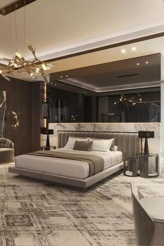 a bedroom with a large bed and chandelier