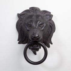 This cast aluminum piece takes the form of a loins head holding a ring in its mouth to create a timeless and functional door knocker. Available in three finishes: Antique Brass, Nickel, and Bronze. Hanging hardware included. Dimensions Overall 12.5"W x 15.75"H x 7.75"D (8 lbs)  Bronze Dust with dry cloth Lion Head Door Knocker, Furniture Pedestal, Rattan Wall Decor, Door Knockers Unique, Acrylic Wall Decor, Accent Wall Decor, Large Wall Decor, Door Knocker, Brass Door