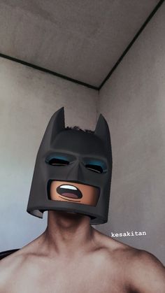 a man with a batman mask on his face and chest is shown in front of the camera