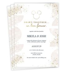 two wedding cards with gold foil and mickey mouse ears on the front, one is in white