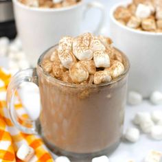 two mugs filled with hot chocolate and marshmallows