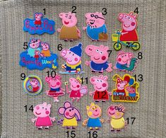 a group of peppa pig magnets sitting on top of a piece of cloth