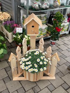 a bird house with flowers in the center