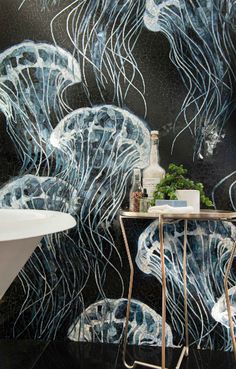 a bath room with a tub and a wallpapered mural on the wall next to a sink