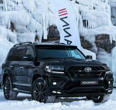 a black suv is parked in front of ice formations