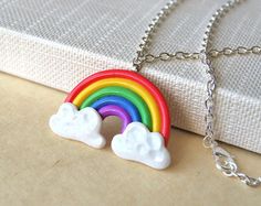 a rainbow and clouds necklace on a chain