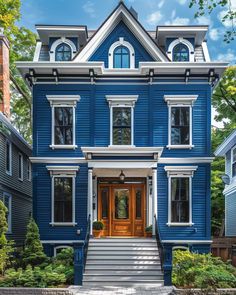 a blue house with white trim on the front door and steps leading up to it