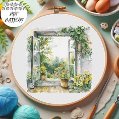 an embroidery kit with flowers and potted plants in front of a window, surrounded by other crafting supplies