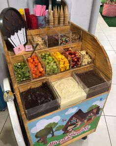 an ice cream stand filled with lots of different types of food and desserts on top of it