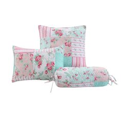 three pillows with flowers on them and one has a zippered pouch in the middle