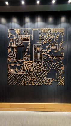 a large metal artwork on the side of a wall in an office building with wood paneling