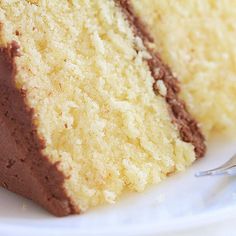 a close up of a slice of cake on a plate with a fork in it