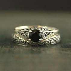 two silver rings with a black stone in the middle