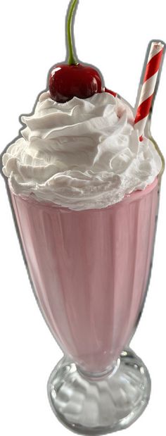 a pink milkshake with whipped cream, cherries and a candy cane on top