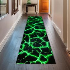 a green area rug on the floor in a hallway