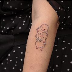 a woman's arm with a small tattoo of an elephant holding a baby in her arms