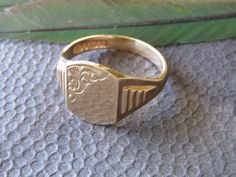 "9 Kt. Gold Signet Ring with Hallmarks for Birmingham, England, 9 Kt. Gold, 1970 and \"C.P.S.\" for a maker's mark.  There is room to place a monogram, but we do not have the equipment to engrave the ring here. This ring is in excellent condition with light scratching to the surface.  It weighs 5 grams." Formal Engraved Ring With Maker's Mark, Vintage Formal Initial Ring, Gold Rings Vintage, Mens Gold Signet Rings, Cowboy Gifts, A Night At The Opera, Ring Inspo, Estate Ring, Estate Rings