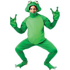 a man in a green frog costume is standing with his hands up and eyes wide open