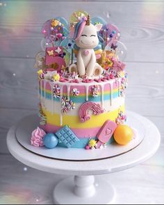 a birthday cake with an unicorn on top