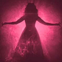 the silhouette of a woman in a long dress with her arms spread out, against a pink background