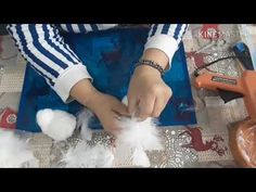 a person is making something with white feathers