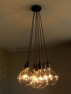 a chandelier with five light bulbs hanging from it