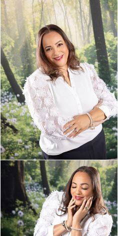 a woman in white shirt and black pants standing next to trees with her hands on her chin