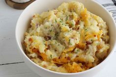 a white bowl filled with mashed potatoes on top of a table