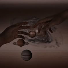 two hands reaching out to touch the planets