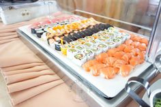 an assortment of sushi on a buffet table