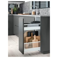 an open cabinet in a kitchen with cutting boards and utensils on the bottom shelf