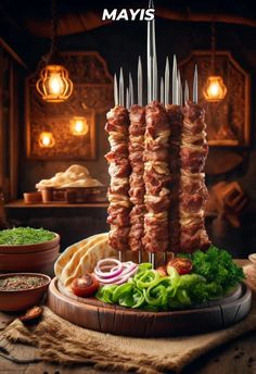 meat skewers are arranged on a platter with various vegetables and sauces