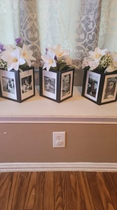 three small vases with flowers in them on a shelf