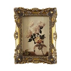 an ornate gold frame holds a painting of white flowers in a glass vase with filigrees